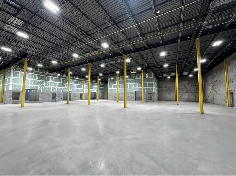 Warehouse interior looking across the open floor toward the office build-out