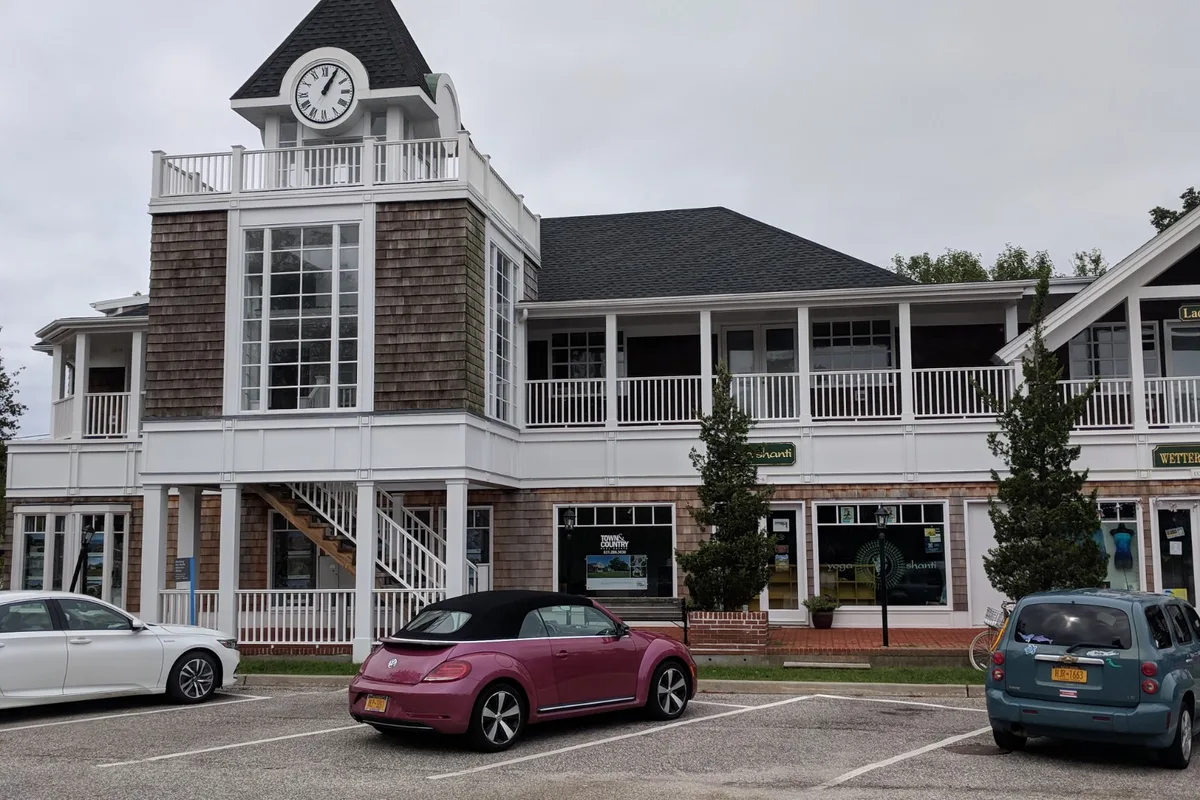 The shingled clock-tower building on Main Street in the Village of Westhampton Beach (a village view, not the Yardarm itself)